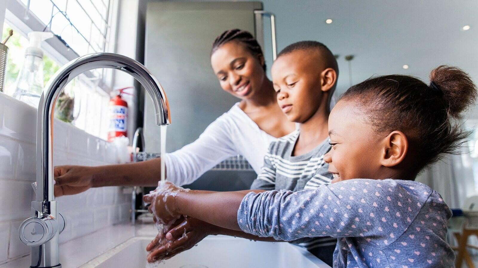 A family enjoying hot and cold water from their Intrix Tap