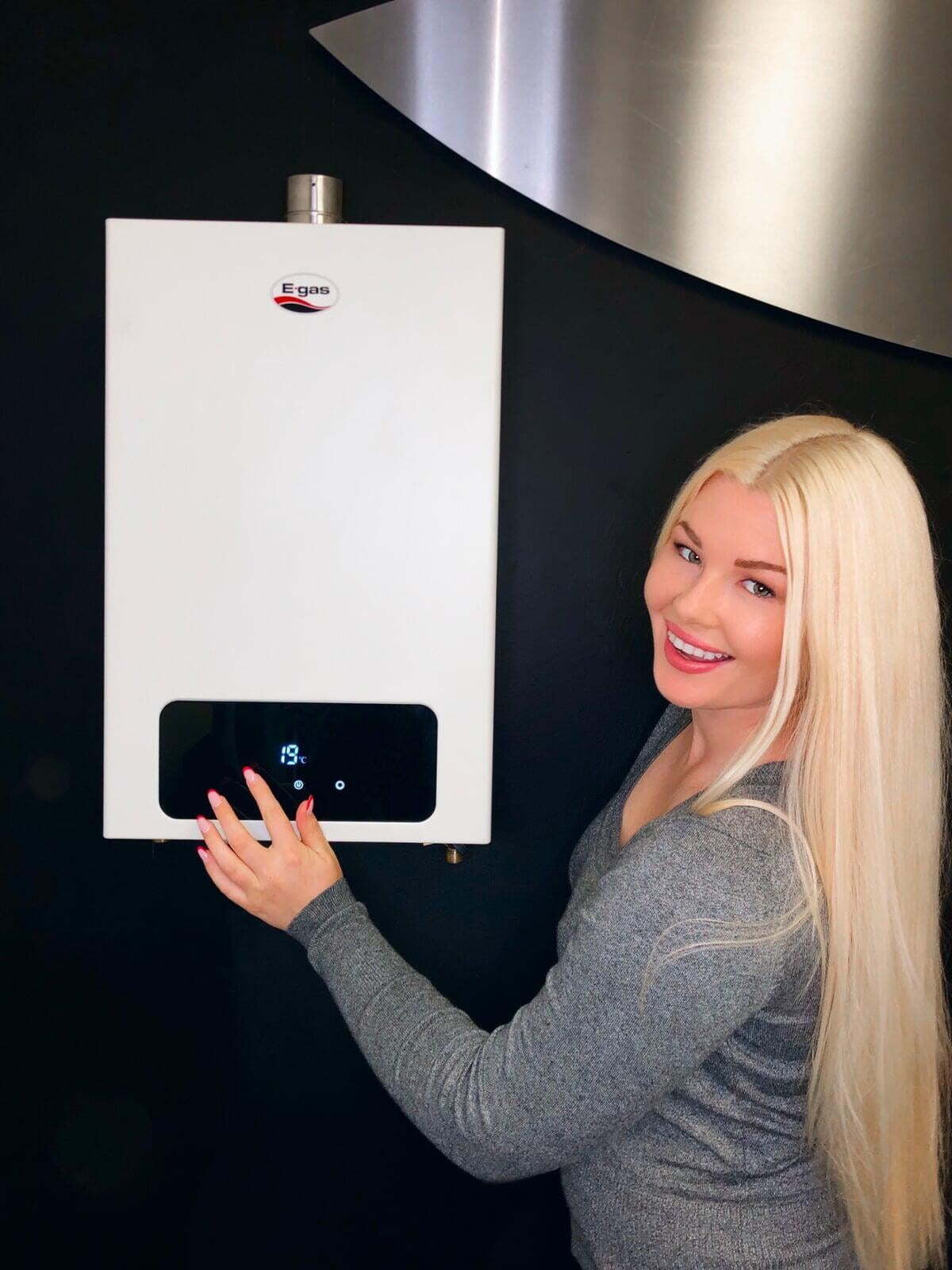 A woman showing how reliable her gas-powered hot water heater system is.