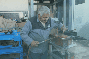 A man manufacturing the BlueWave hot water heater 