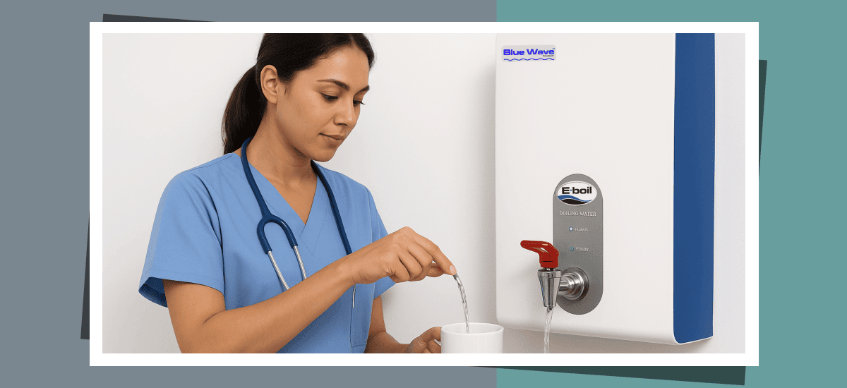 A nurse pouring boiling water into a mug from a BlueWave Boiling Water Dispenser