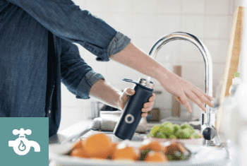 A Man pouring water from an Intrix Boiling Water Tap