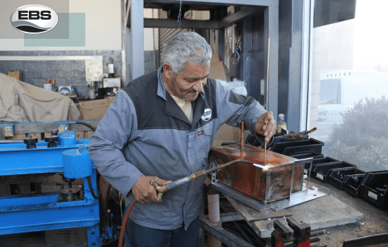 A man repairing a Hydroboil unit in South Africa