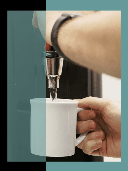 A mug being filled with boiling water from a Parisi E-Bev boiling water dispenser