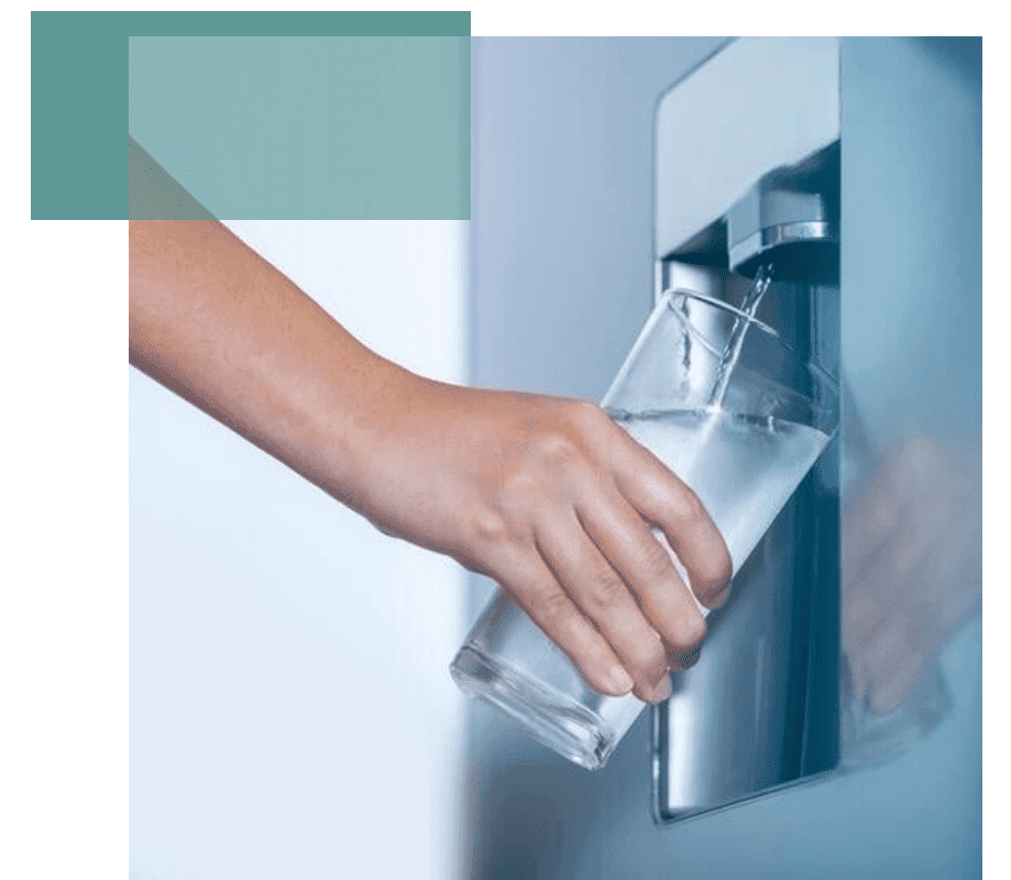 A person filling their glass with water from a chilled water dispenser