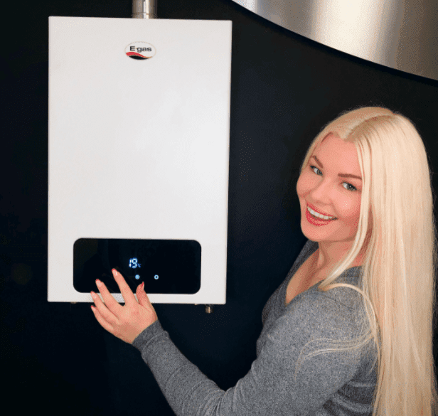 A woman installing a high-quality and reliable gas geyser unit for heating water.