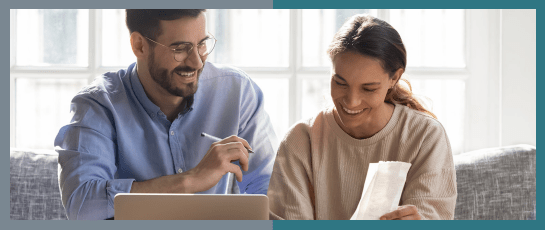 A couple smiling at their bills after using an instant water heater