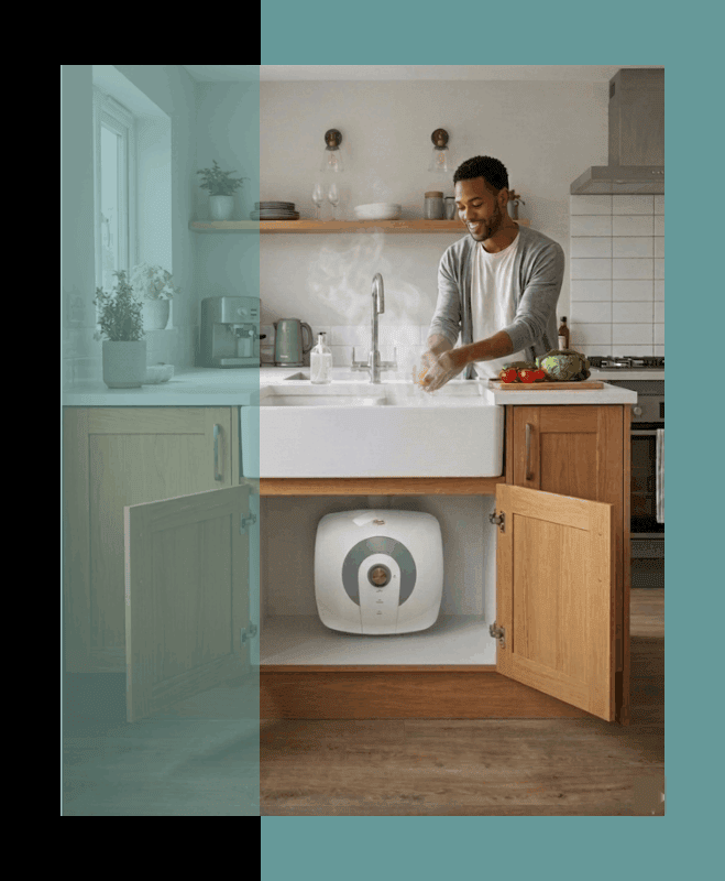 A man rinsing food in his kitchen, using hot water from his Parisi Mini Geyser