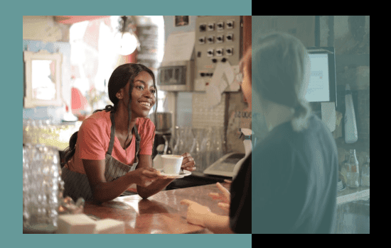 A barista serving a customer at a coffee shop