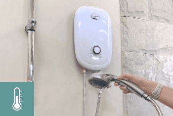 A woman using the e-cotherm instant water heater and rose shower head