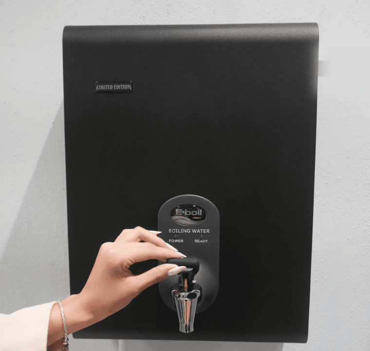 A wall mounted black BlueWave water heater