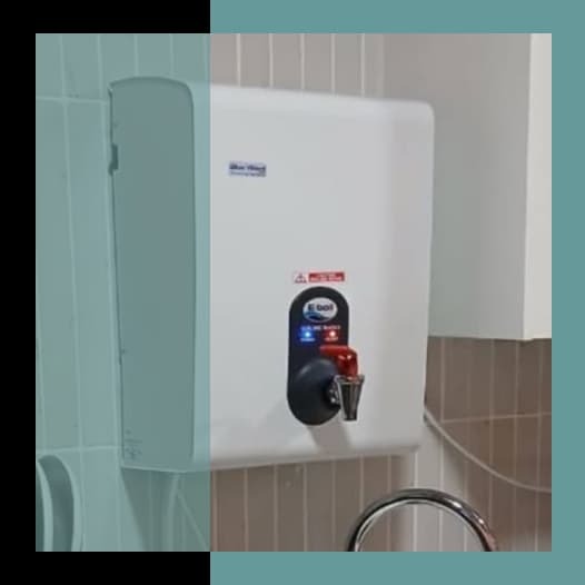 BlueWave wall-mounted boiling water dispenser installed in the compact head office kitchen at Cape Union Mart, Cape Town