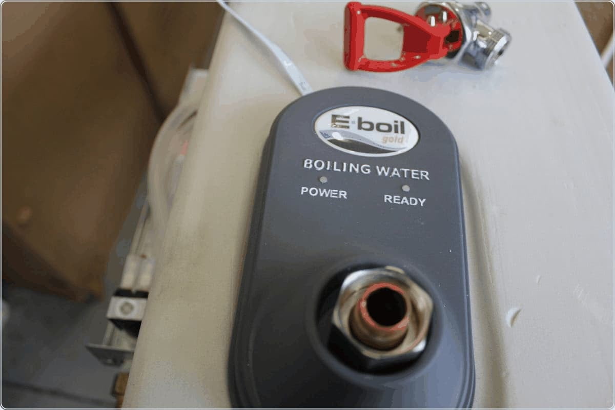 Close-up of the digital control unit on a BlueWave boiling water dispenser, showing power and ready indicators