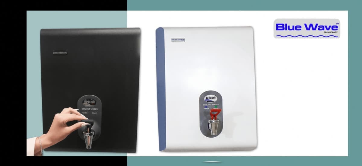 A hand turning the tap on a matte black Limited Edition BlueWave boiling water unit next to the standard white BlueWave unit with blue trim.