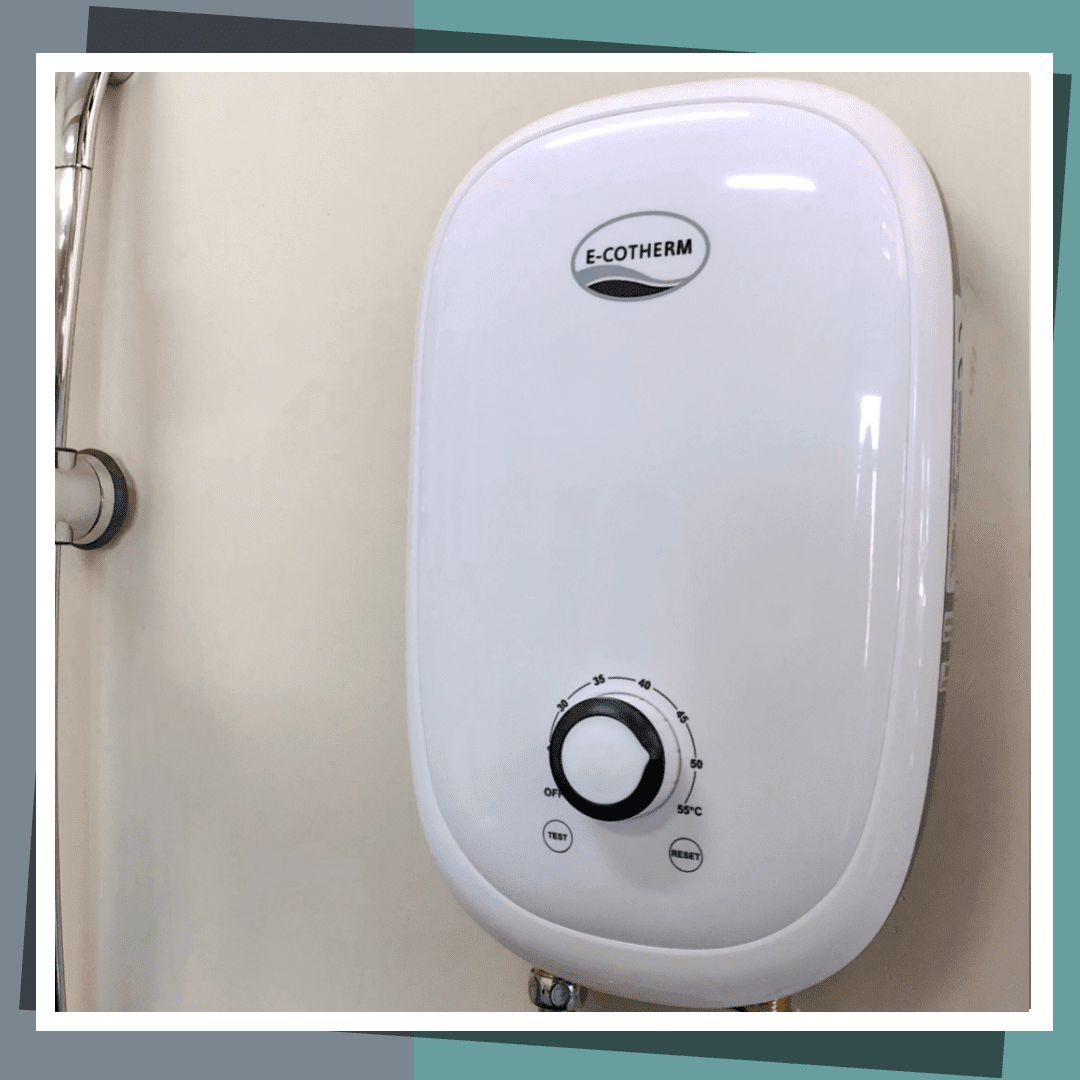 An E-Cotherm tankless electric water heater neatly installed in a bathroom shower