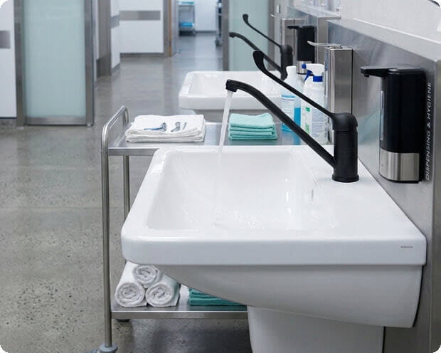Row of hand-wash basins along a corridor