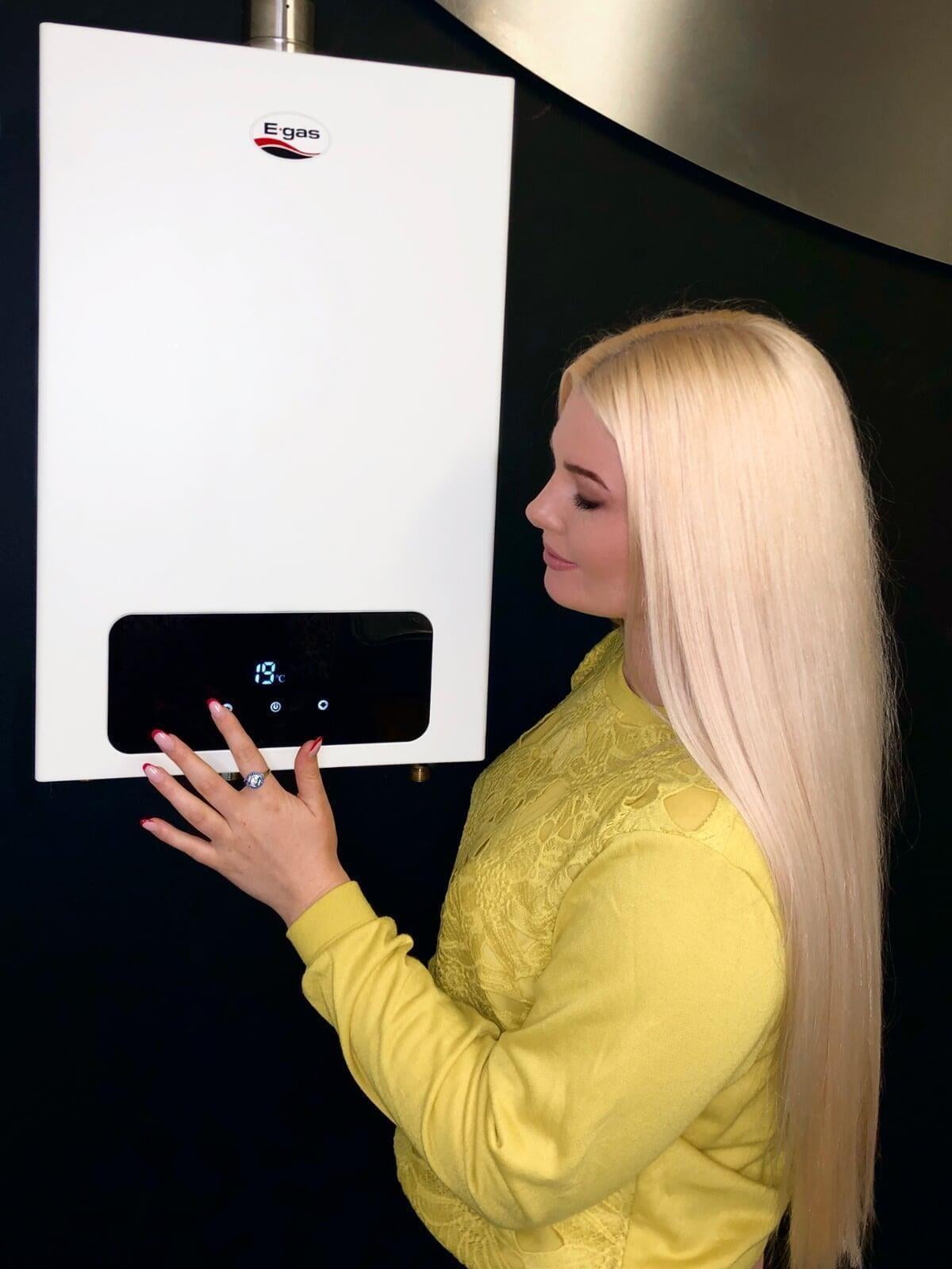 A woman setting her energy-efficient propane water heater for hot water on demand.